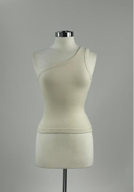 A sleeveless one-shoulder top in white, crafted from organic cotton and designed to emphasize the body figure.