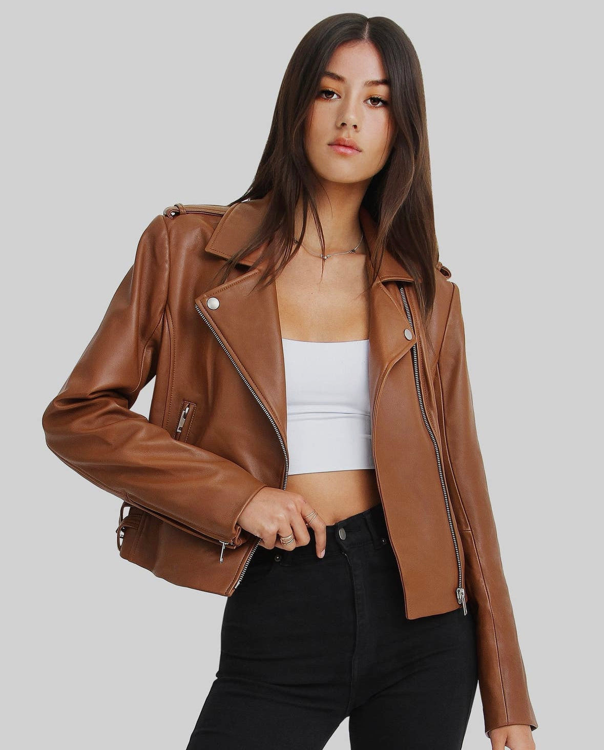 Leather jacket crafted from genuine sheep leather with silver-toned hardware. It features a zip-through front, notched lapels, zip-open cuffs, and two zipped pockets.