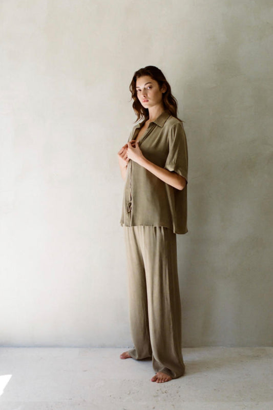 A collared blouse with mid-length sleeves in an attractive army green color.