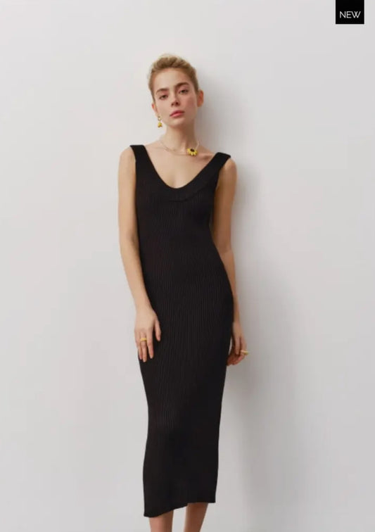A black silhouette dress made from delicate natural cotton fabric, designed to emphasize your figure with a below-the-knee length and plunging neckline.