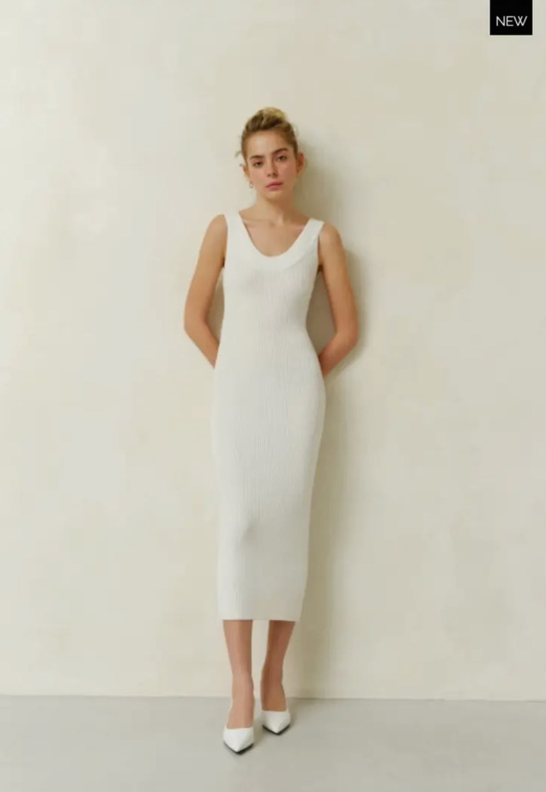 A white silhouette dress crafted from delicate natural cotton fabric, designed to accentuate your figure with a below-the-knee length and plunging neckline.