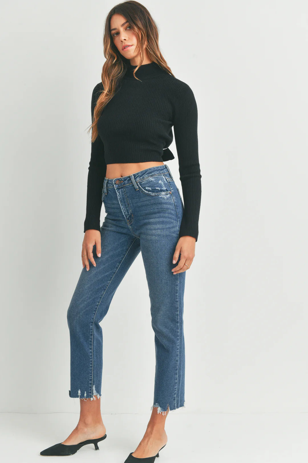 Indigo vintage-washed straight jeans with a distressed hem. These jeans have a rise of 10 inches and an inseam of 27 inches.