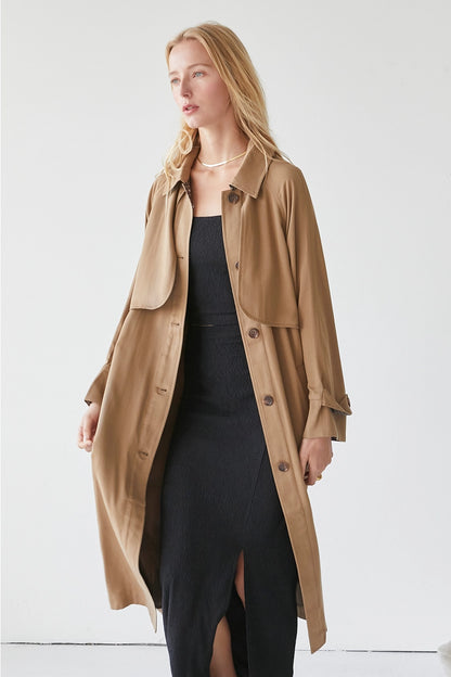 A Tencel trench coat with a neat button fastening in the middle, offering a sophisticated and stylish outerwear option.