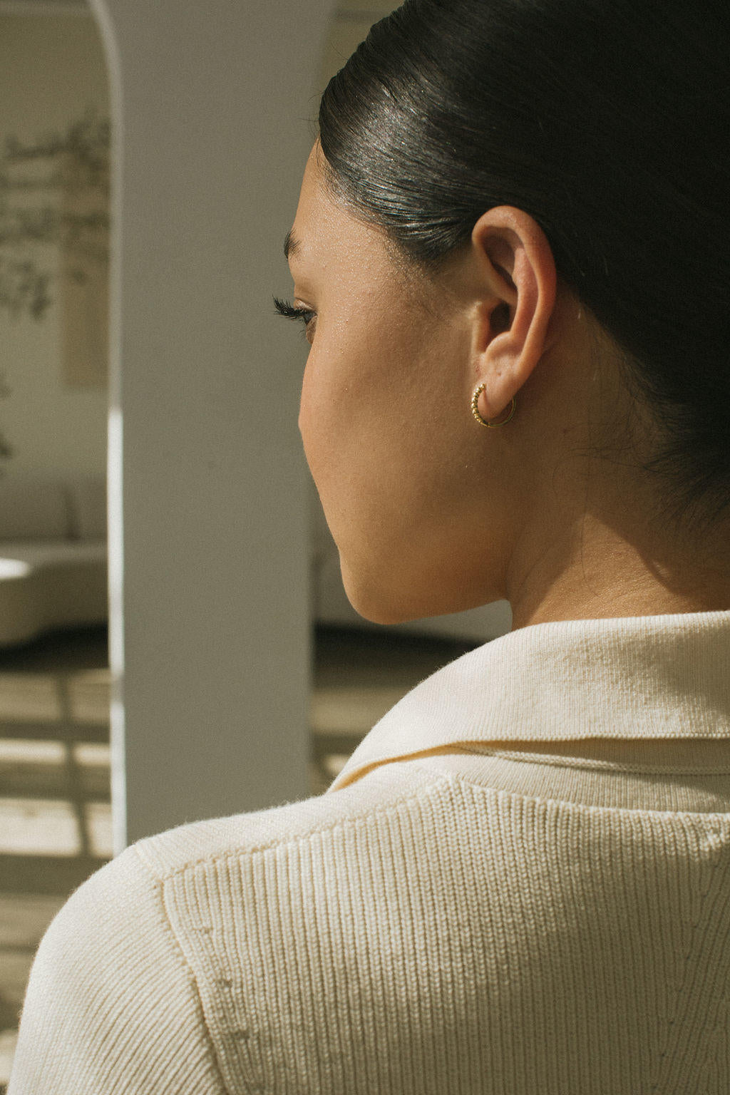 Gold-plated hoop earrings with brass bold ball details, delicately designed.