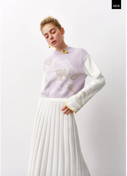 A Lavander knitted sweater with a light print, featuring a classic crew neck and contrasting sleeve detail. The sweater has long sleeves, a round neck, and an oversized print.